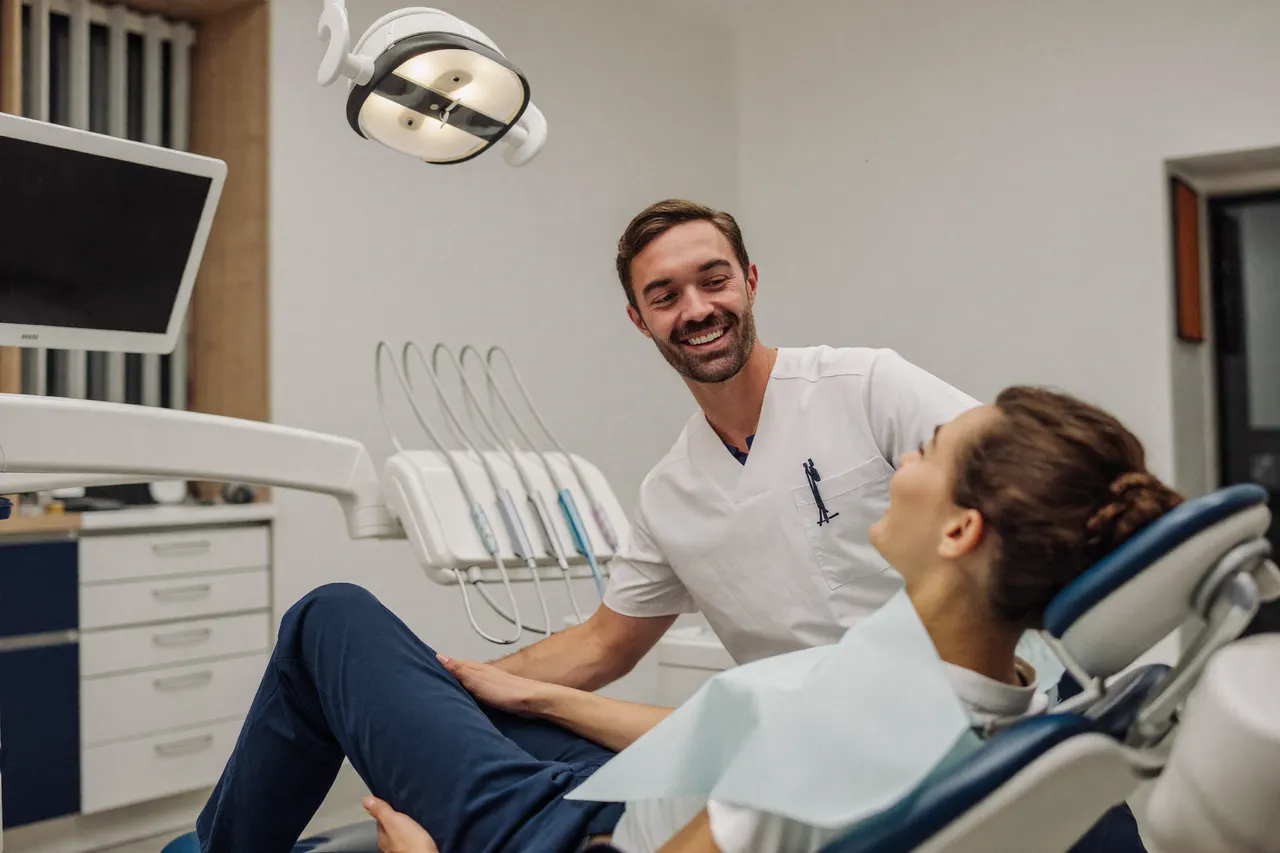 Dentist talking with a patient in a bright modern treatment room